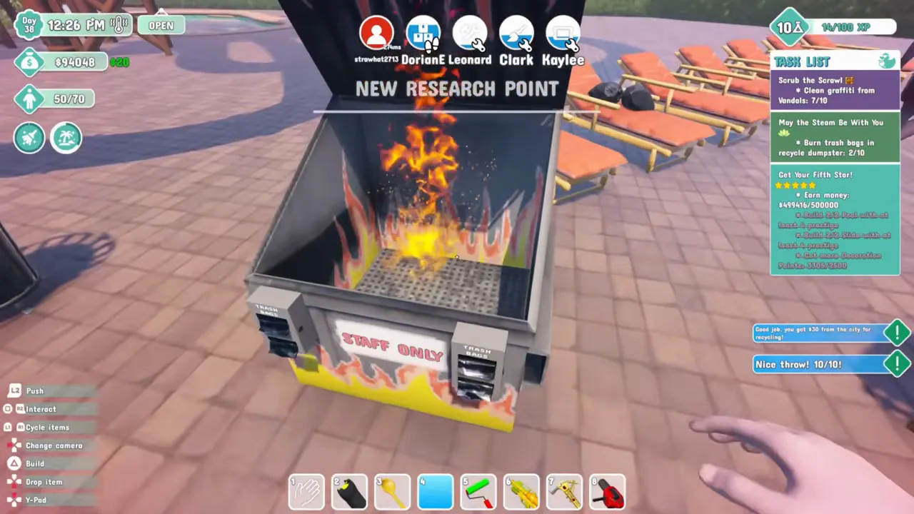 Flames rising inside an open black and yellow Staff Only recycle dumpster after a trash bag lands in it, with New Research Point on screen