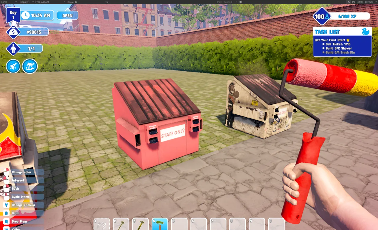 A freshly painted pink Staff Only dumpster beside a battered old dumpster on day one of a park, with the player holding a paint roller