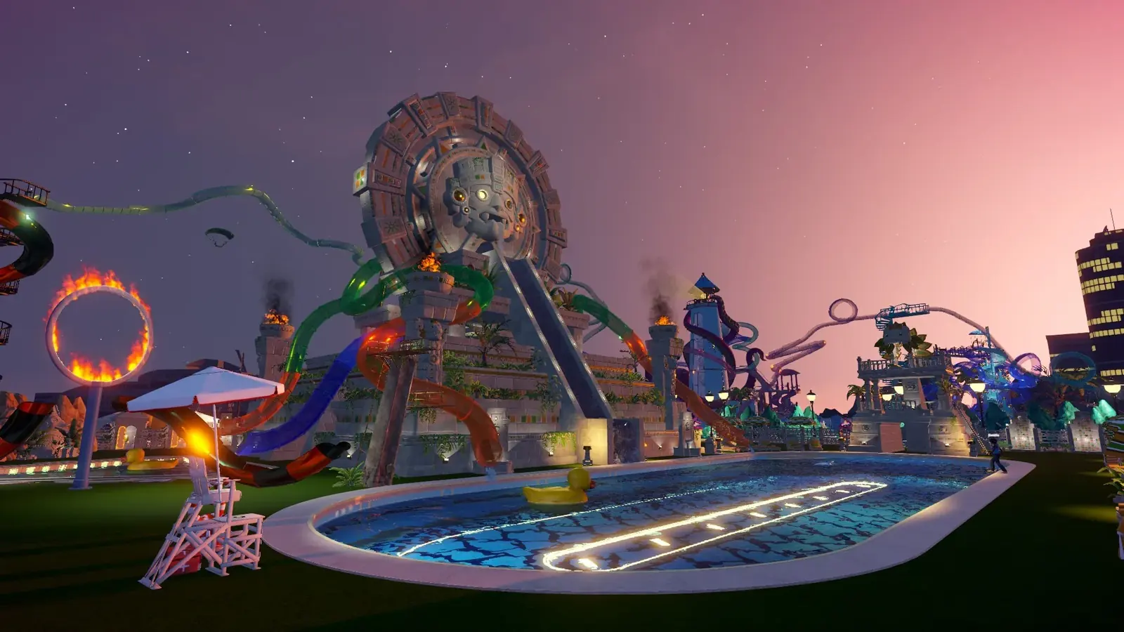 An Aztec-themed Waterpark Simulator park at night with lit slides and a flaming ring feature